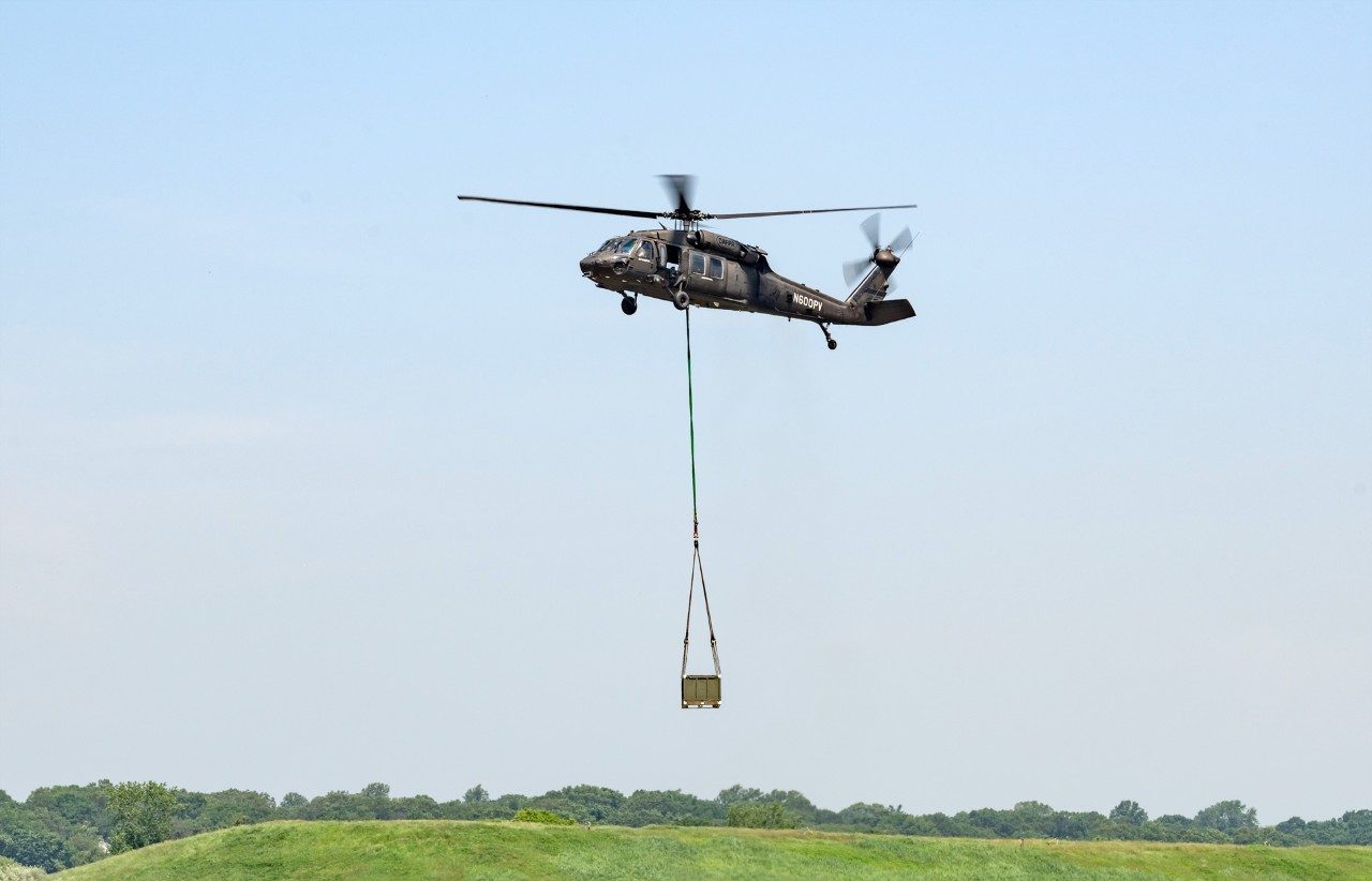 The optionally piloted Black Hawk helicopter flies with a sling load in full autonomy mode during the ALC demonstration at Sikorsky’s Stratford, Conn., HQ.